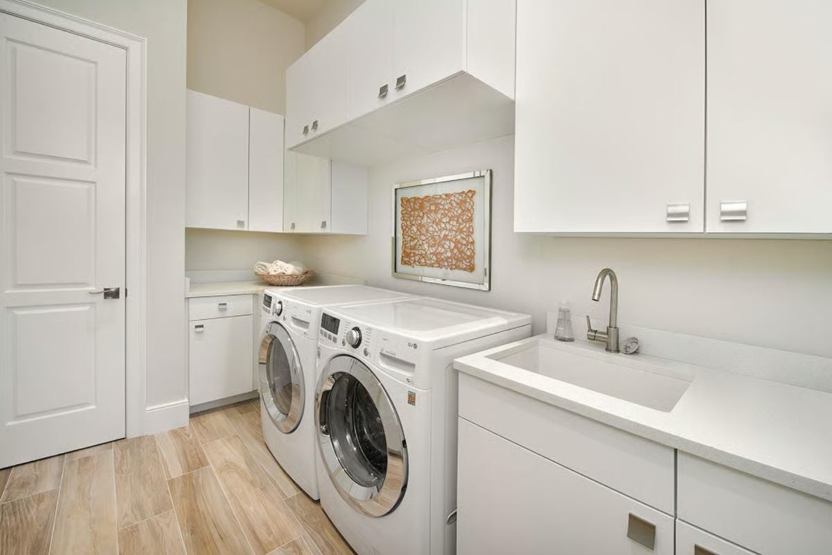 Folded Towels, a Utility Sink Off-Center, and Cabinets That Go All the Way Up