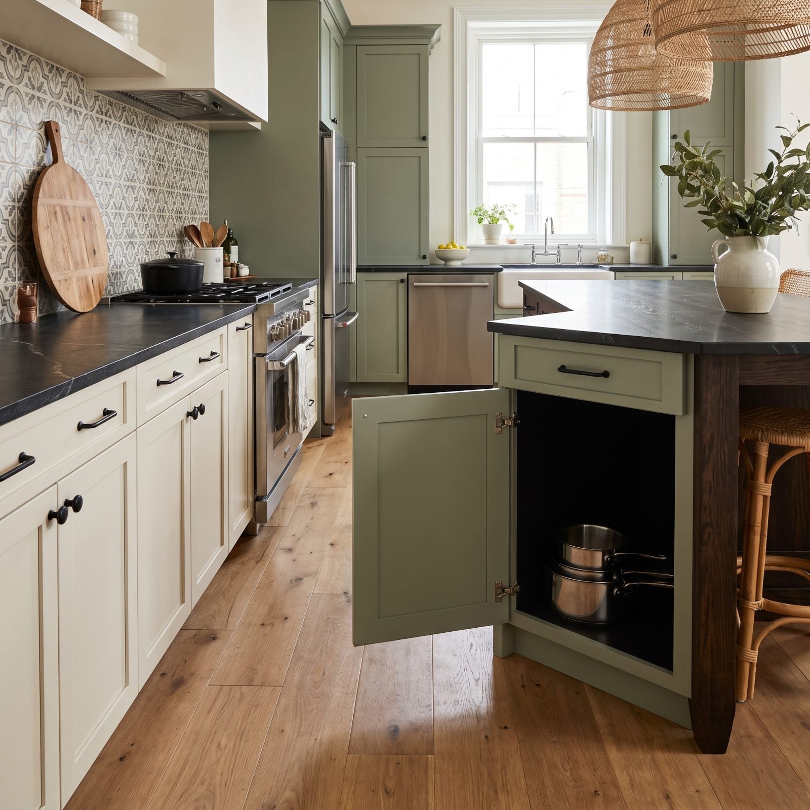 Cream kitchen with an open base corner cabinet showing a deep L-shaped void with pots at the front only.