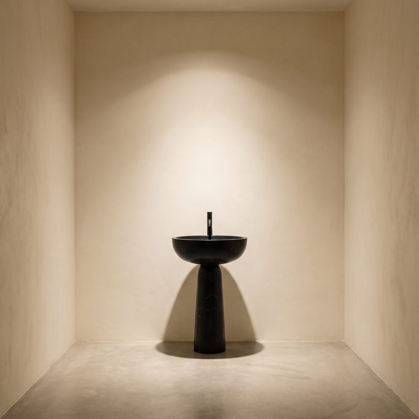 Cream Bathroom With a Sculptural Black Pedestal Sink