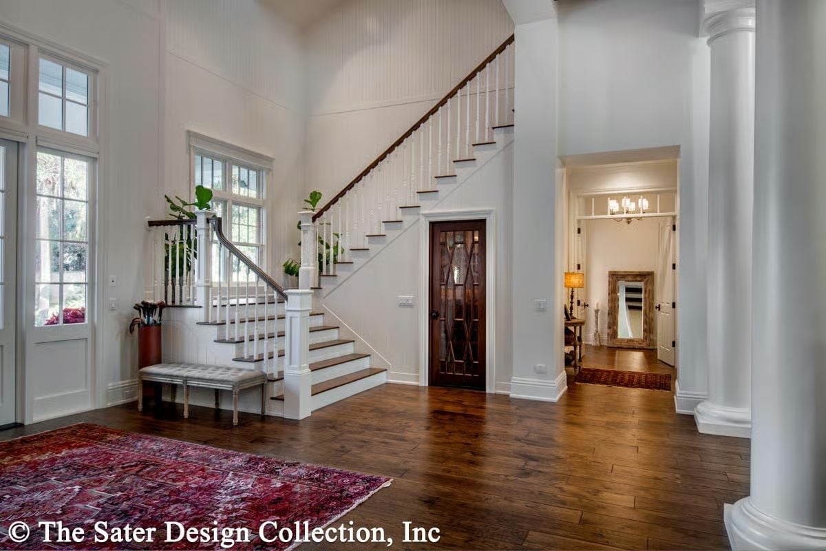Grand Two-Story Foyer Where the Staircase Does the Heavy Lifting