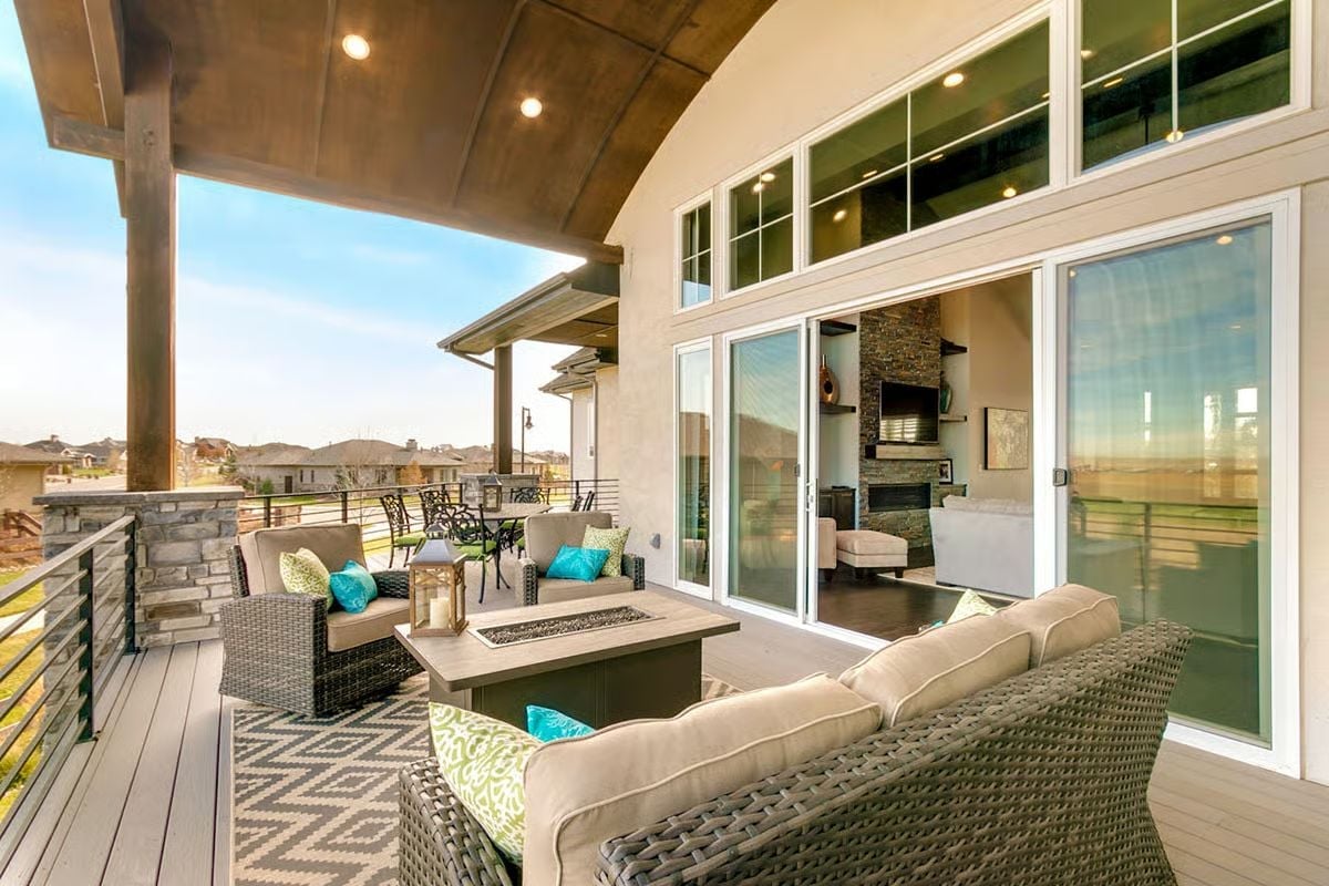 Covered Deck with a Fire Table and Sliding Glass That Opens the Wall