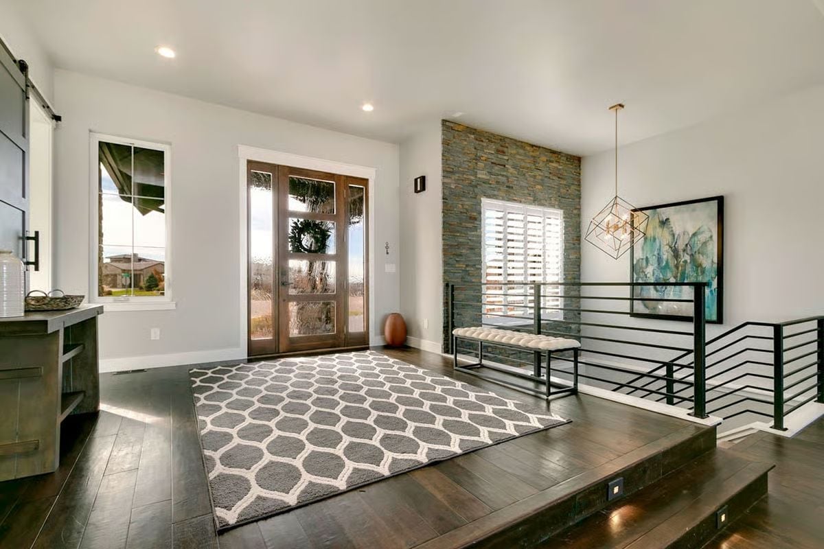 Raised Entryway with Stone Accent Wall and Industrial Railing