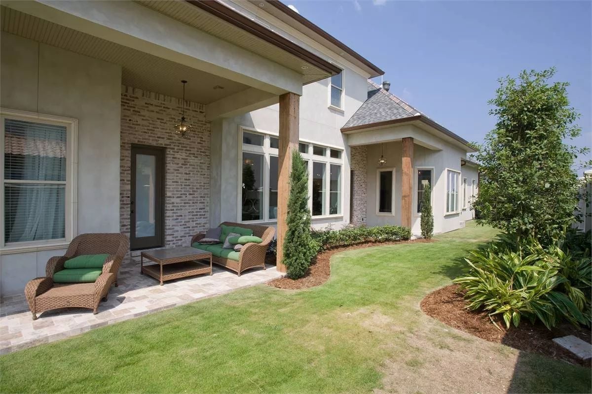 Covered Patio With Wood Columns and Wicker Seating Built for Louisiana Summers