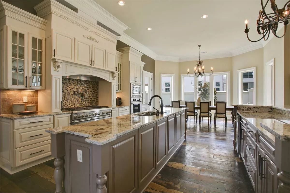 Cream Cabinetry, Gray Island, and a Range Hood Built Like Furniture