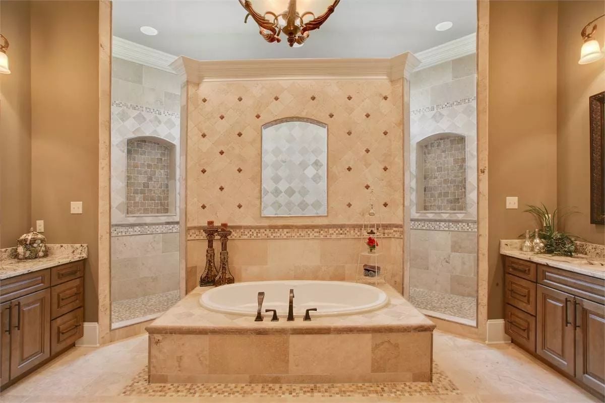 Marble Surround Soaking Tub Flanked by Two Walk-In Showers Built for a Couple