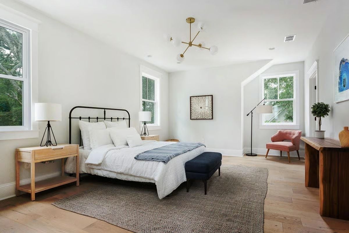 Iron Headboard, Pink Chair, and a Brass Sputnik Light Share a Room Without Fighting