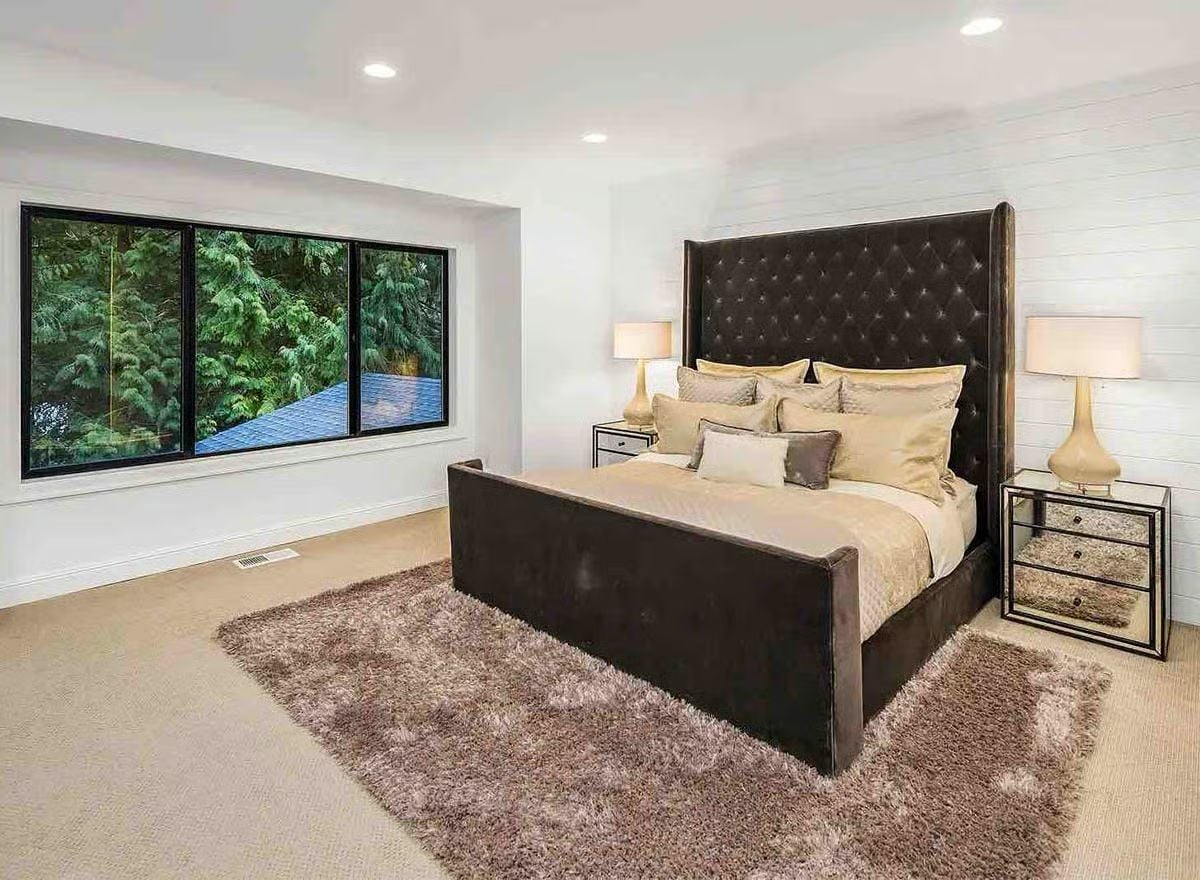 Dark Velvet Headboard Tall Enough to Make the Ceiling Feel Like a Deliberate Choice