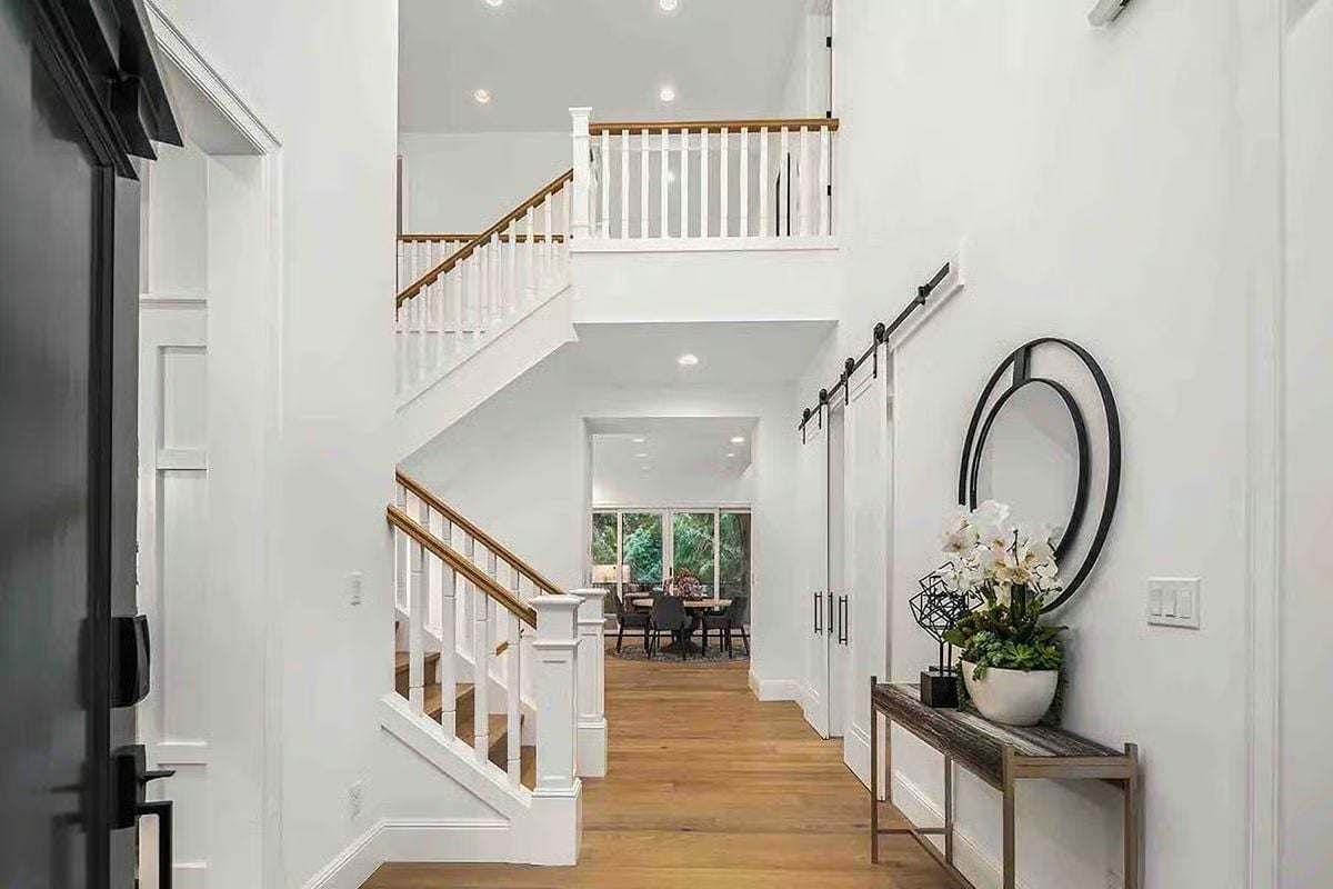 Two-Story Foyer Where the Barn Door and the Balcony Split Your Attention Equally