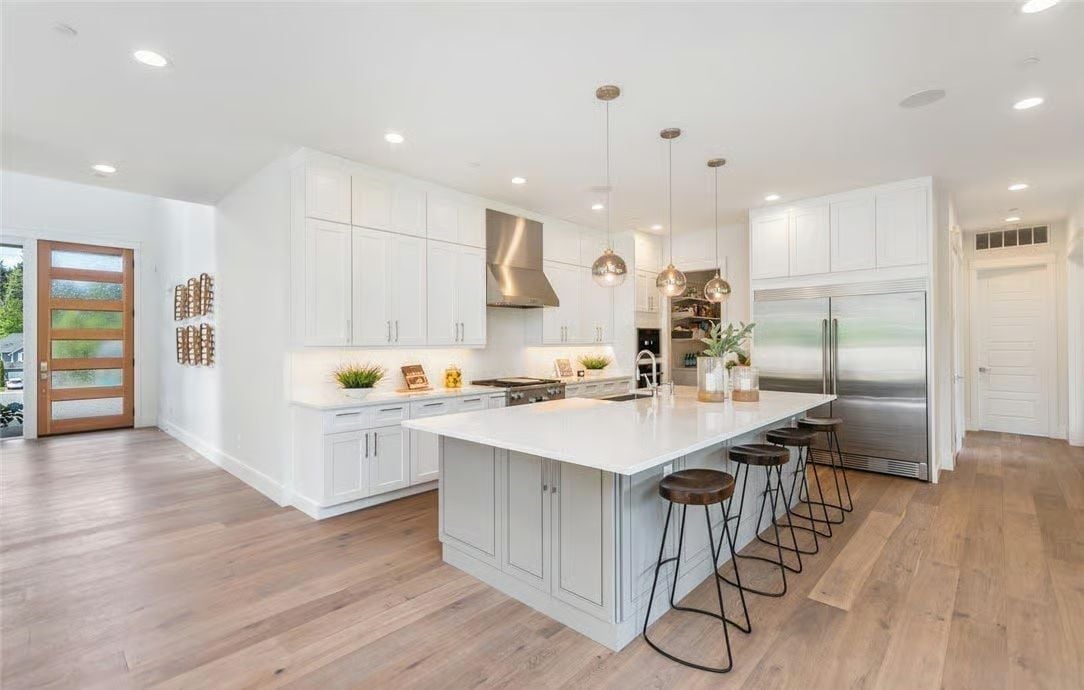 Pale Gray Island, White Shakers, and Three Pendant Lights That Don't Match the Ceiling