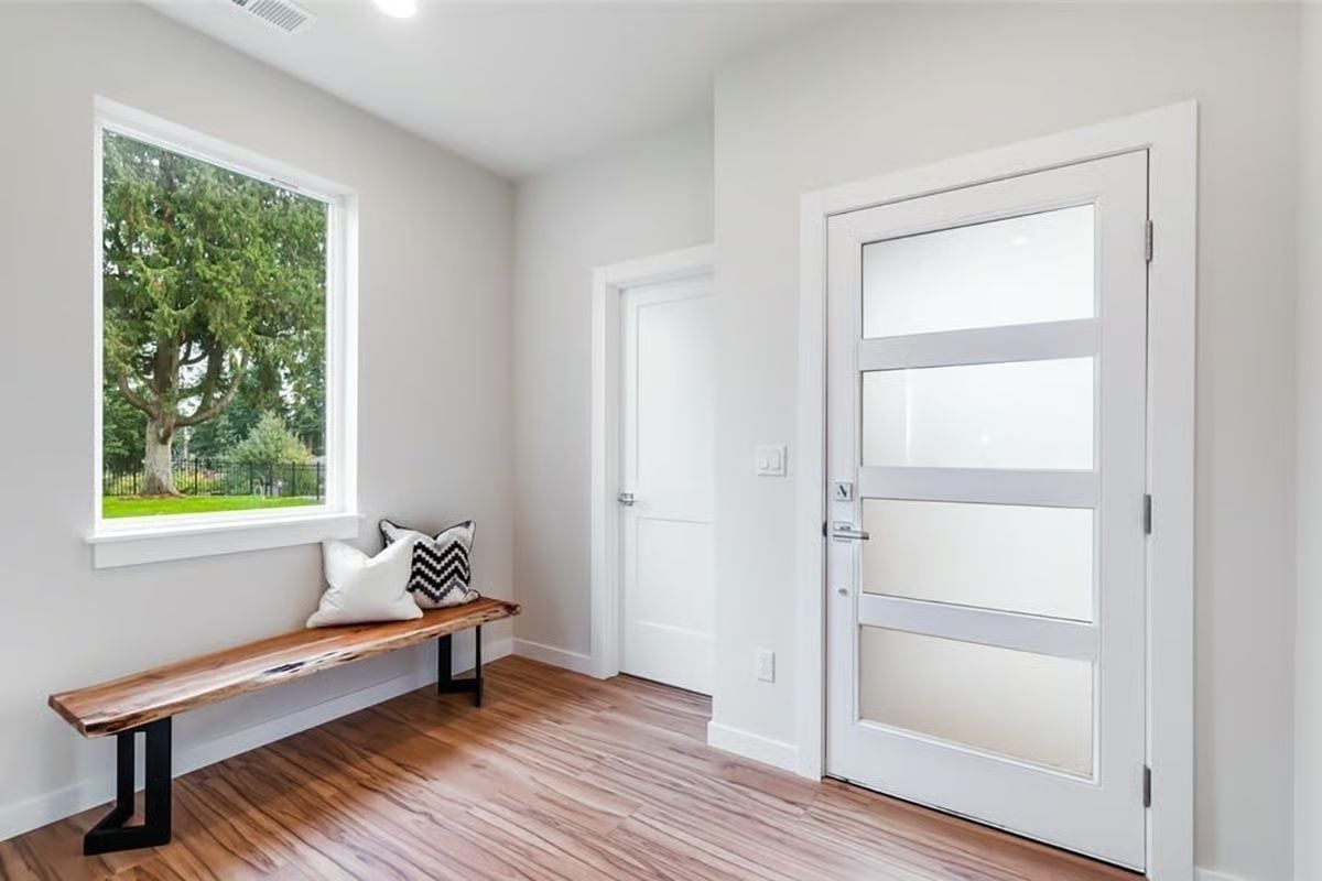 Live-Edge Bench and Frosted Glass Entry Door Set the Tone Before You're Even Inside
