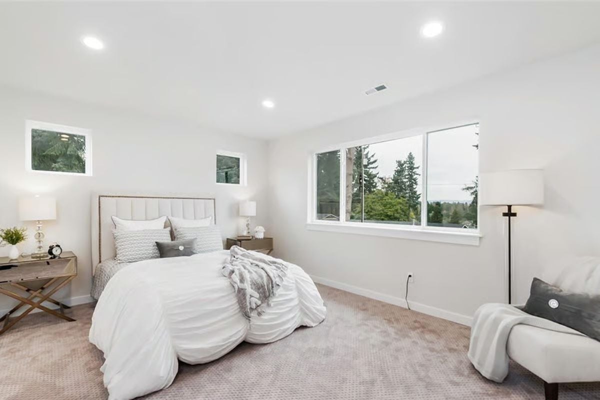 Recessed Lighting and Clerestory Windows Keep This Primary Bedroom Bright Without Feeling Exposed