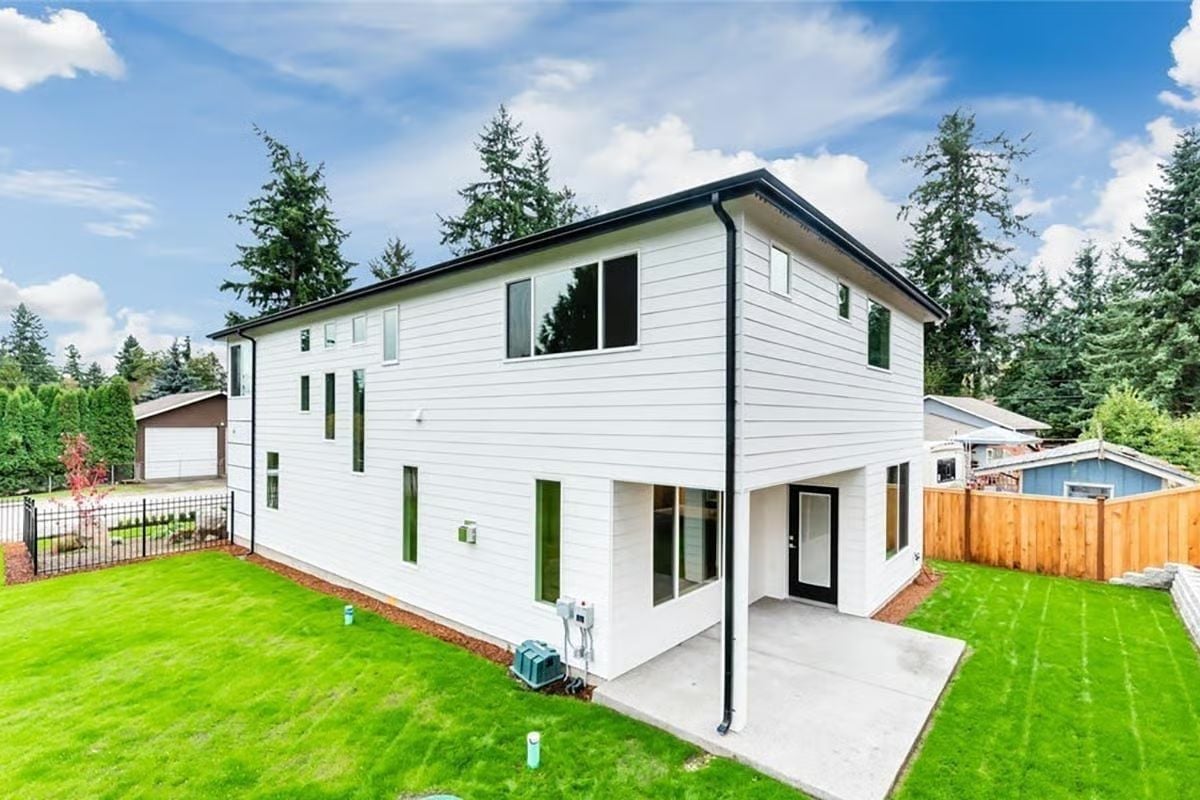 White Horizontal Siding and Black Trim Give This Backyard Elevation Real Presence