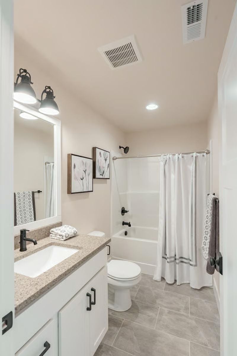 Matte Black Hardware Does the Heavy Lifting in a Neutral Bathroom
