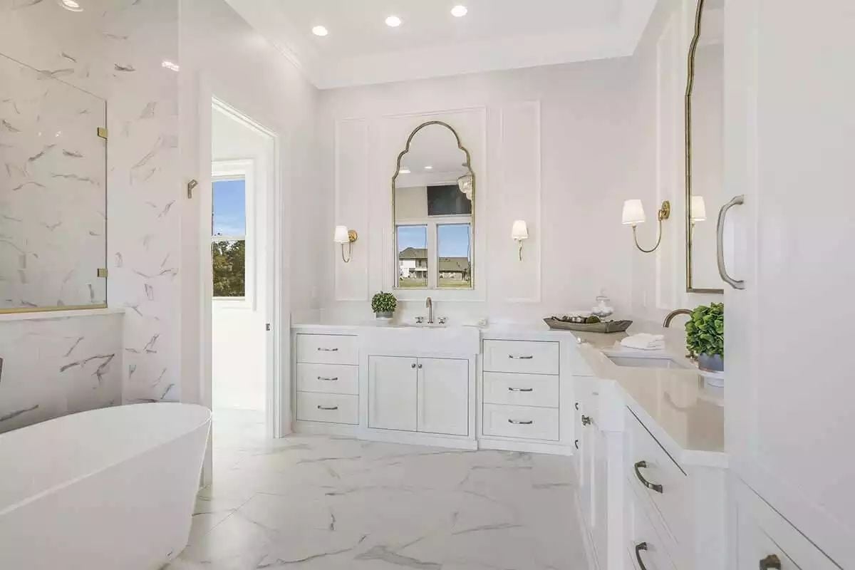 Arched Mirror, Brass Sconces, and a Vanity Built Like Furniture