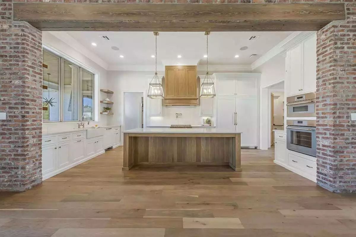 Brick Columns, Reclaimed Beam, and a Kitchen That Earns the Entrance