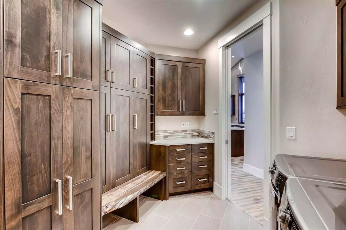 Live-Edge Bench and Floor-to-Ceiling Cabinetry in a Mudroom Built to Mean Business