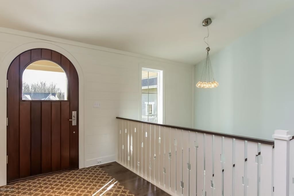 Arched Entry Door Doing More Work Than the Rest of the Foyer Combined