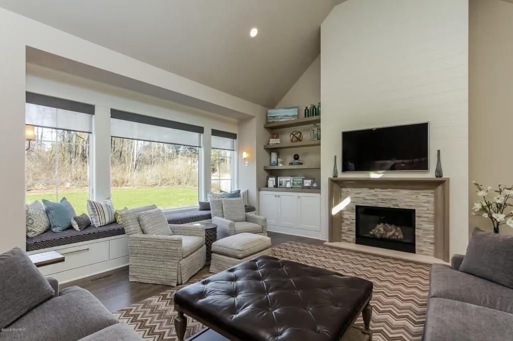 Chevron Rug, Tufted Ottoman, and a Fireplace That Pulls Everything Together