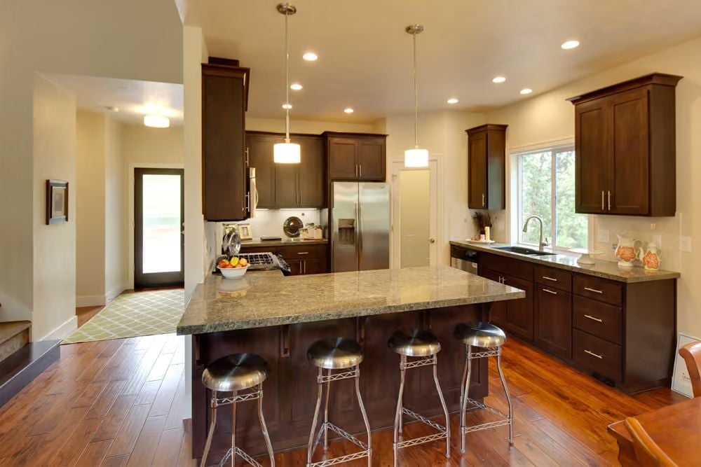 Dark Walnut Cabinets and a Granite Island Built for Serious Cooking