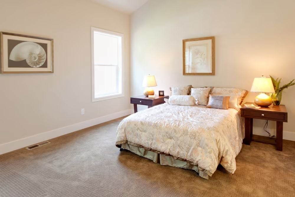 Nautilus Art and Layered Pillows Give This Bedroom a Coastal Without Trying Too Hard