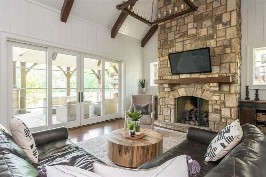 Stone Fireplace, Vaulted Beams, and Leather Sofas That Mean Business