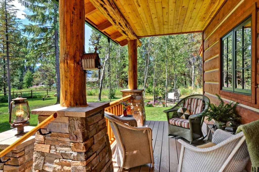 Stone Base Columns and Lantern Light Make This Porch Worth Sitting On