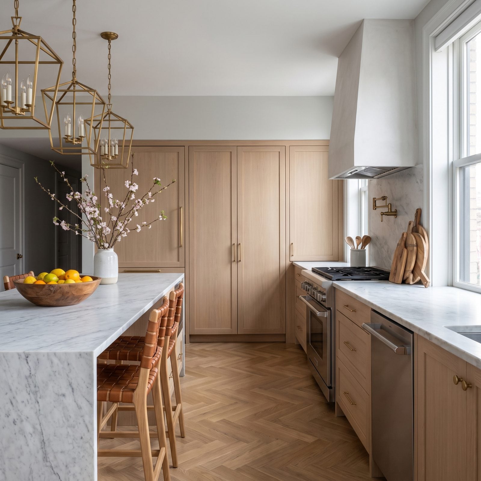 White oak kitchen with four identical tall paneled doors where the fridge and pantry are indistinguishable.