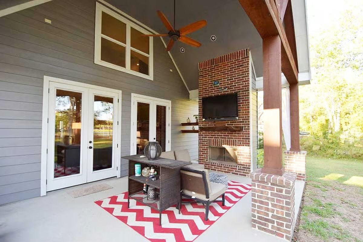 Covered Porch With a Brick Fireplace That Actually Earns Year-Round Use