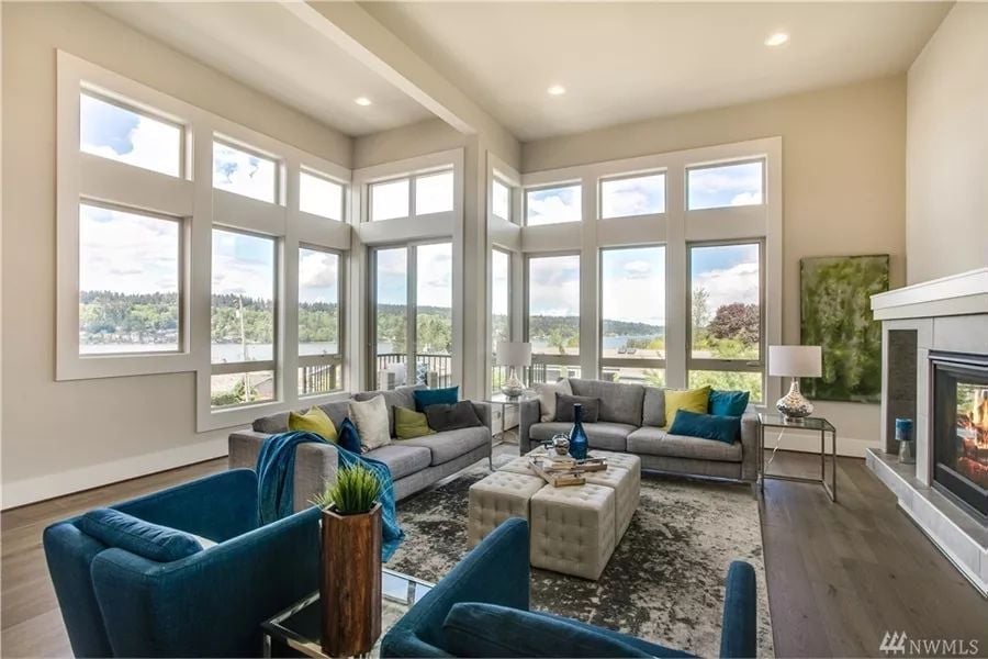Floor-to-Ceiling Windows That Make the Fireplace Work Harder to Compete