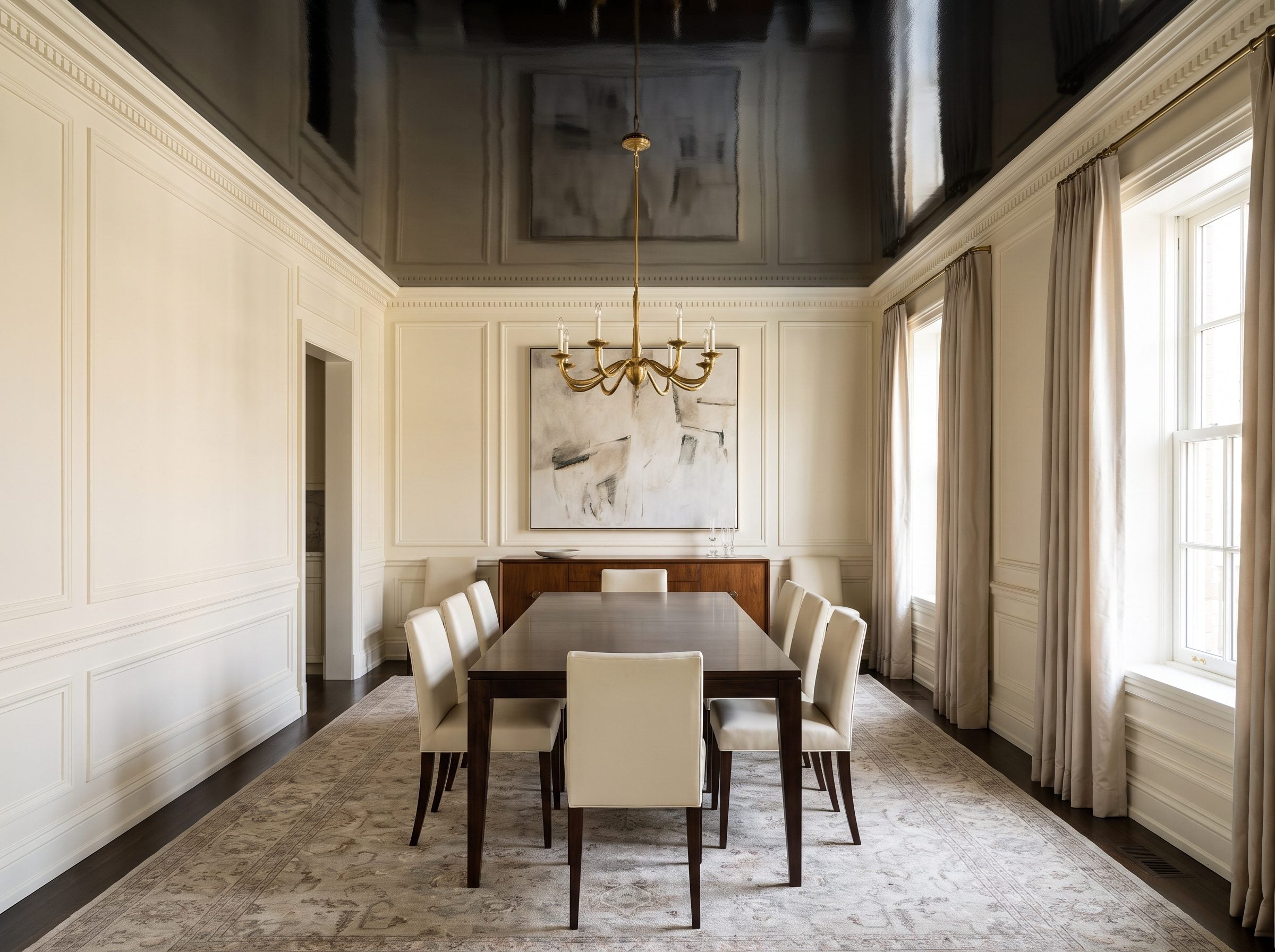 Formal dining room with a high-gloss black lacquered ceiling reflecting a brass chandelier above a walnut table set for