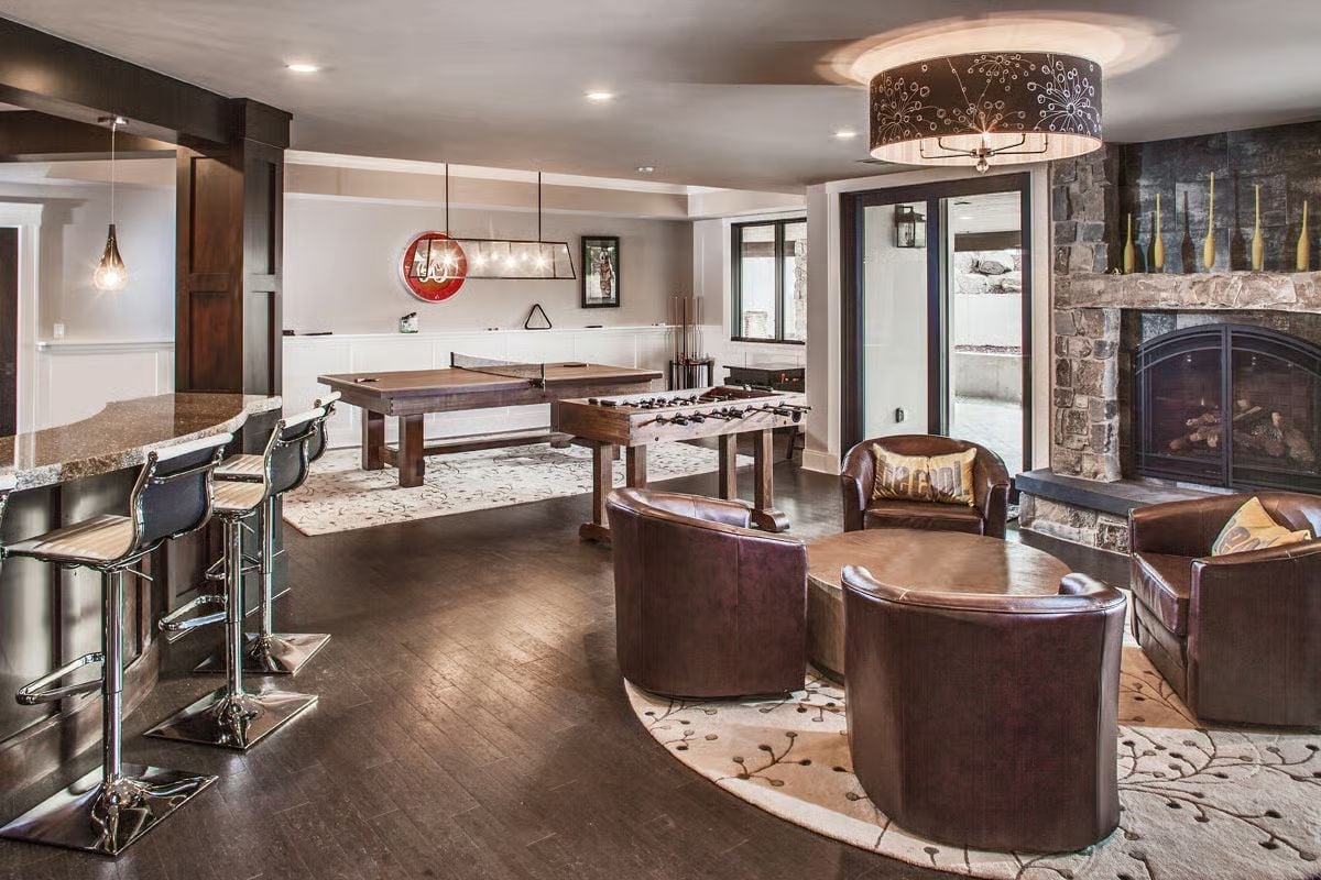 Foosball, Leather Barrel Chairs, and a Stone Fireplace Walk Into a Basement Bar