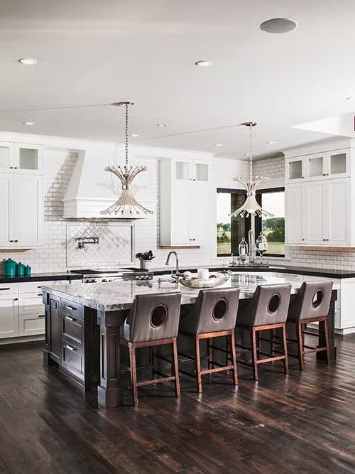 Marble Waterfall Island, Dark-Stained Wood, and Four Leather Barstools That Mean Business