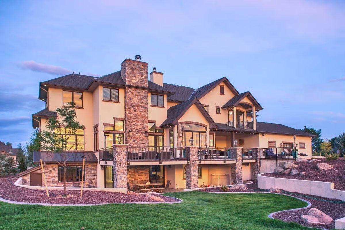 Stone Chimneys, Wraparound Deck, and a Backyard Grade That Does Real Work