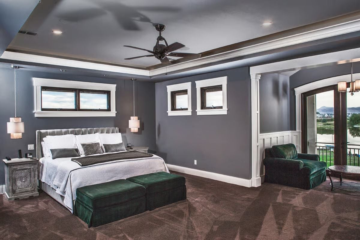 Velvet Ottomans, Tufted Headboard, and a Tray Ceiling That Earns Its Square Footage