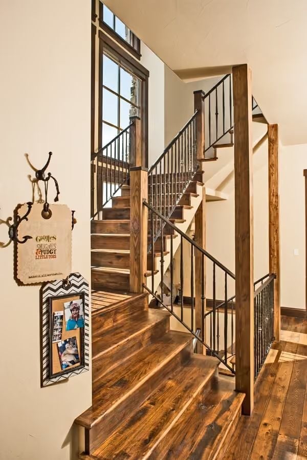 Reclaimed Wood Staircase Where Iron Balusters Pull Their Weight