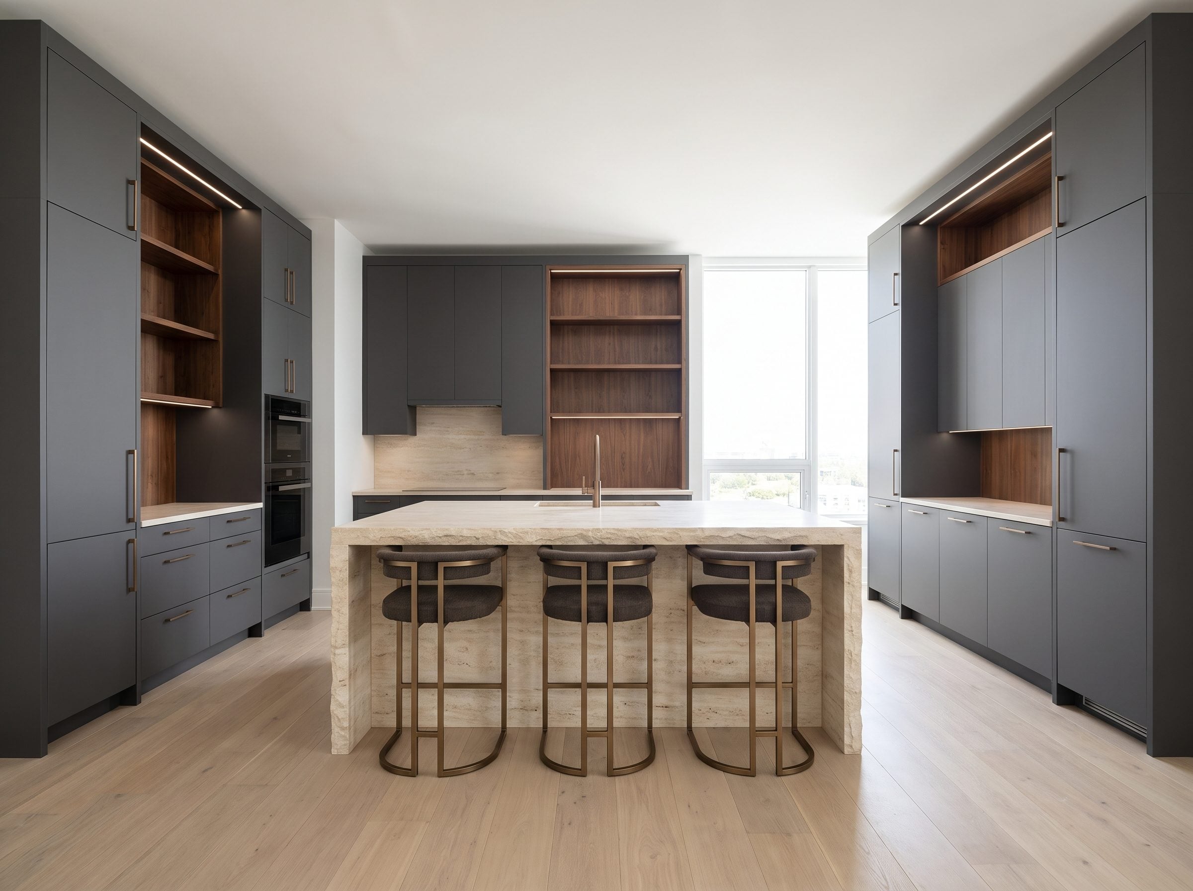 Contemporary kitchen with floor-to-ceiling matte graphite cabinetry and a creamy stone waterfall island with three walnut