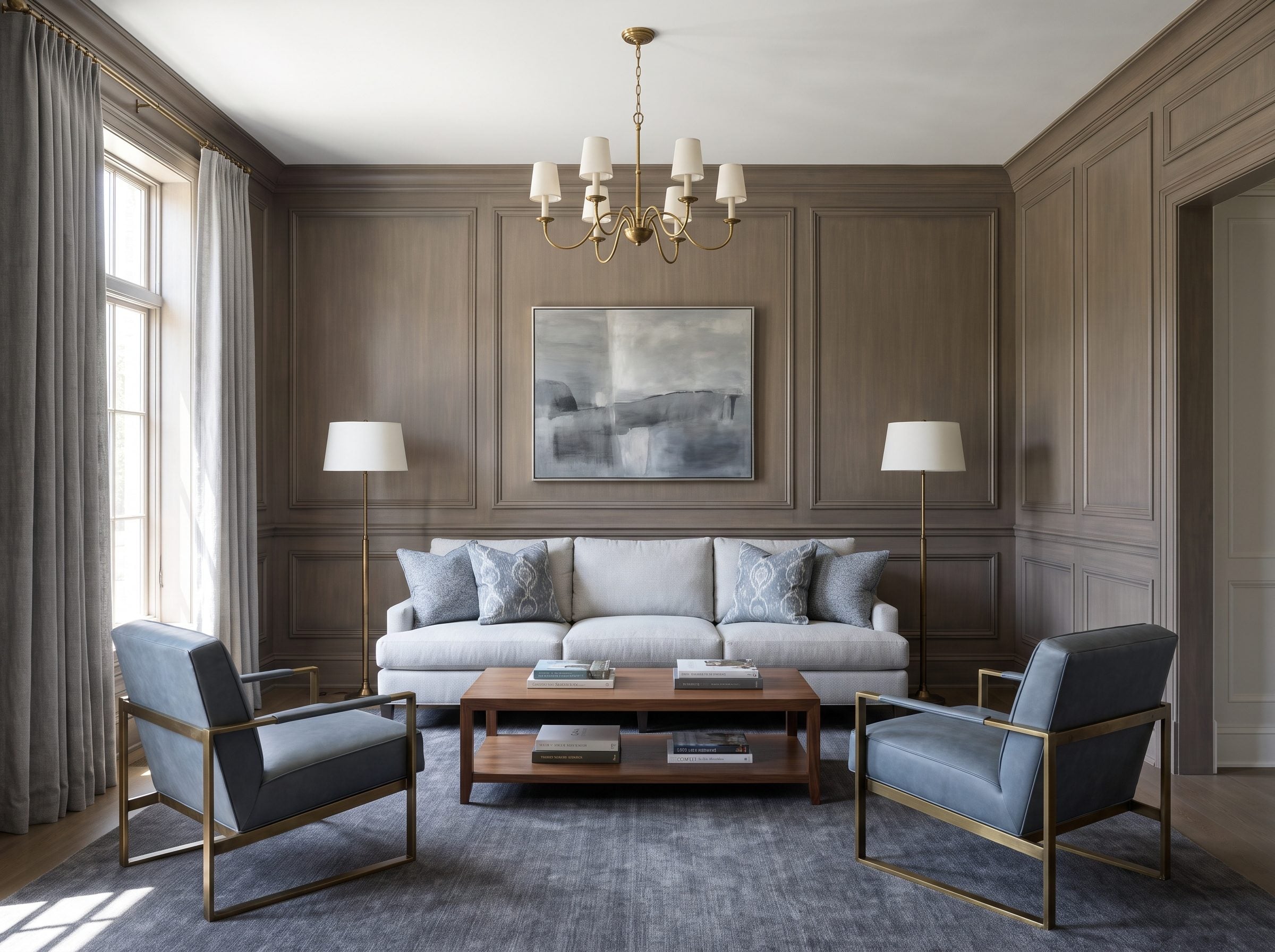 Sitting room with warm-gray paneled walls, a pale-gray sofa on a charcoal rug, and two slate-blue armchairs close in value