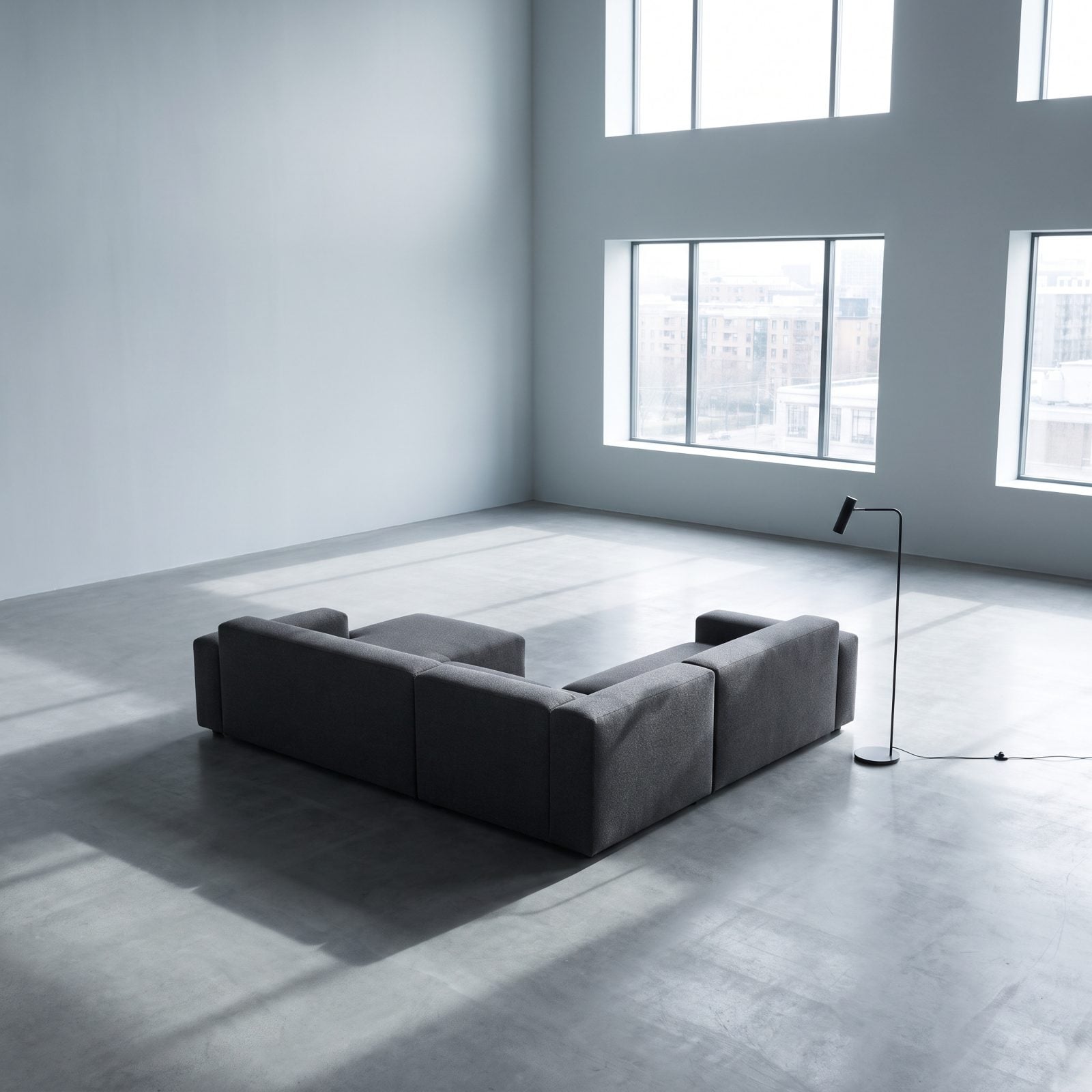 A Gray Sofa Making Sparse Furnishings Feel Unwelcoming