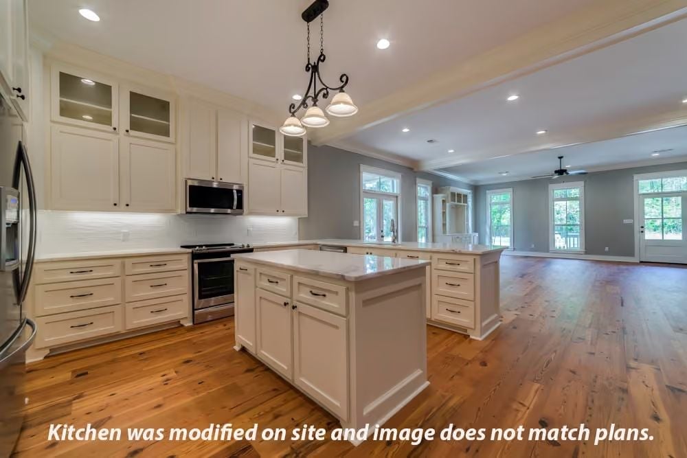White Cabinets, Warm Wood Floors, and an Island That Earns Its Square Footage