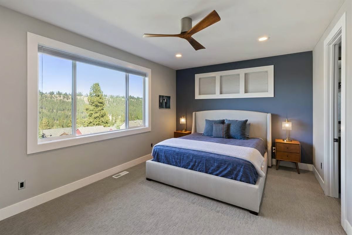 Navy Accent Wall, Wood-Blade Fan, and a View That Does All the Heavy Lifting
