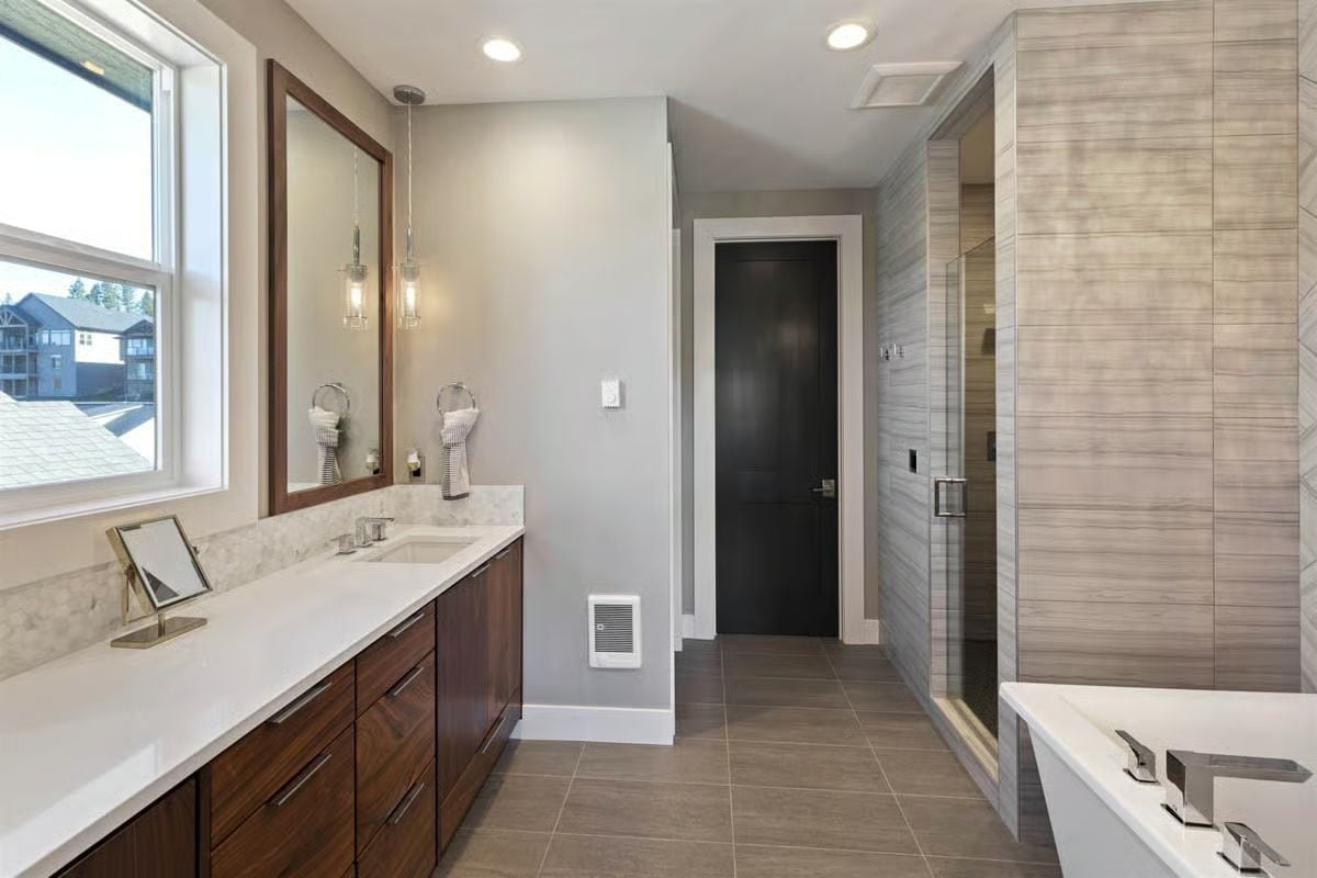 Walnut Vanity Cabinet, Pendant Lights on a Chain, and a Shower Tiled Floor to Ceiling
