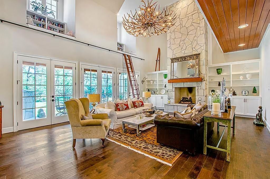 Antler Chandelier Anchors a Double-Height Great Room Built Around Stone and Wood
