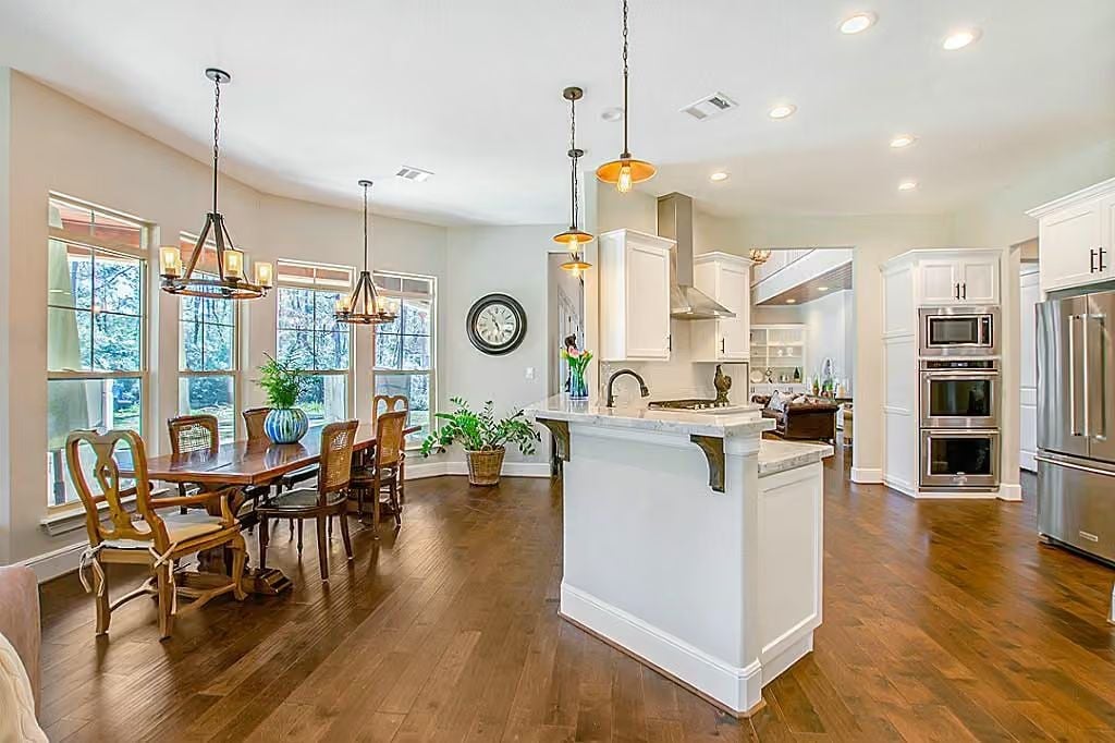 Pendant Lights Over a Marble Island Earn Their Keep in This Open-Plan Kitchen