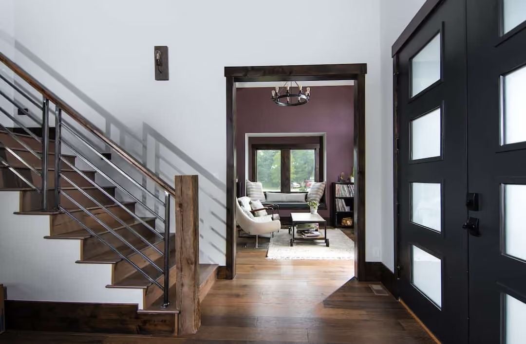 Dark Trim and a Plum Accent Wall Set the Tone Before You Take a Step Inside