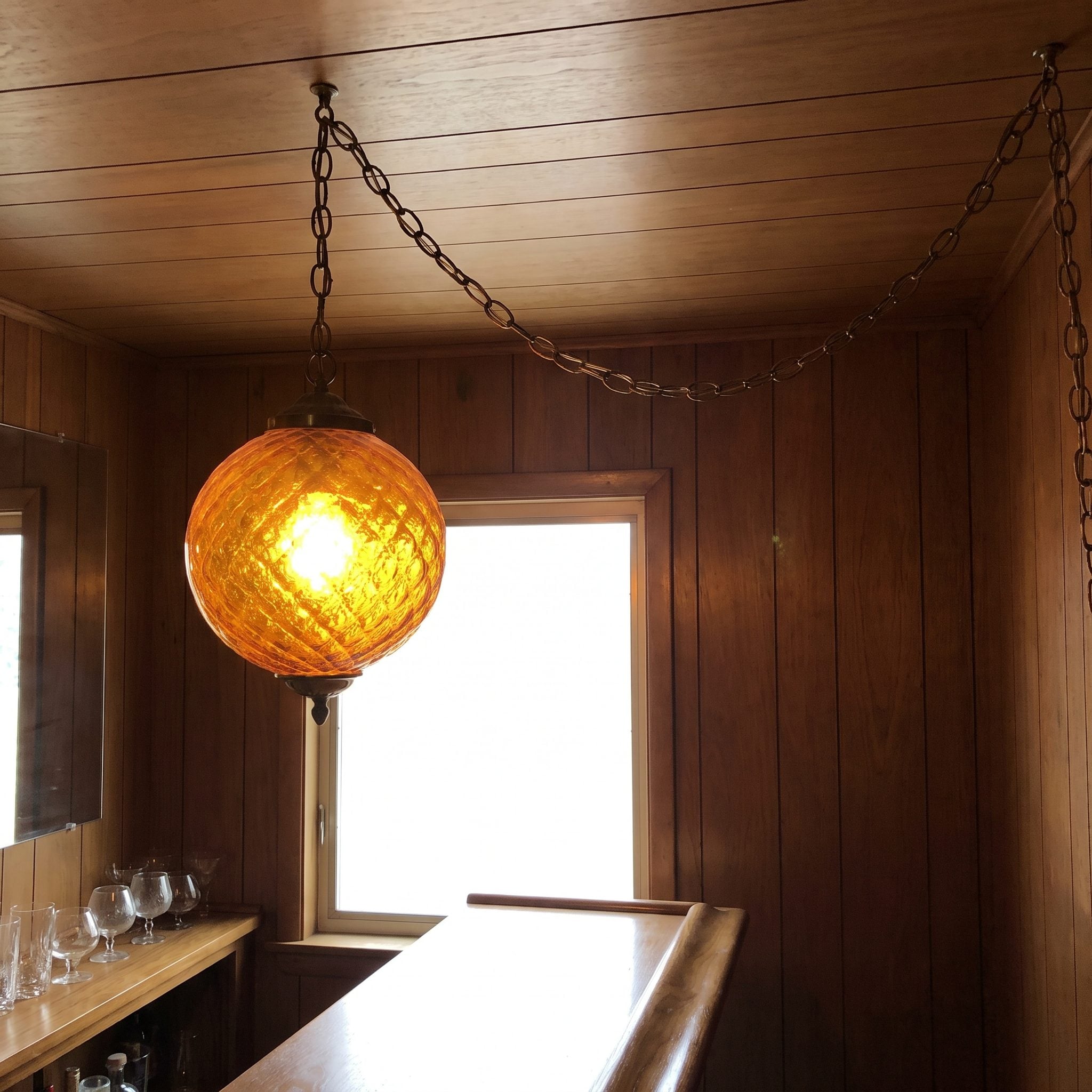 The Hanging Swag Lamp Glowing Directly Over the Bar