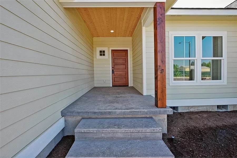 Cedar Post and Concrete Steps Frame a Covered Entry Built to Last