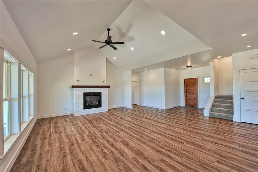 Vaulted Ceilings and a Brick Fireplace Anchor an Open Living Room Built for Gathering