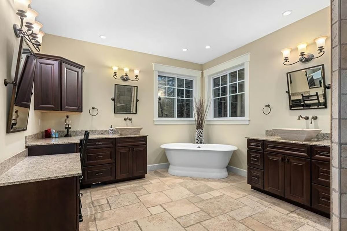 Freestanding Tub Centered Between Two Vanities That Don't Share a Mirror