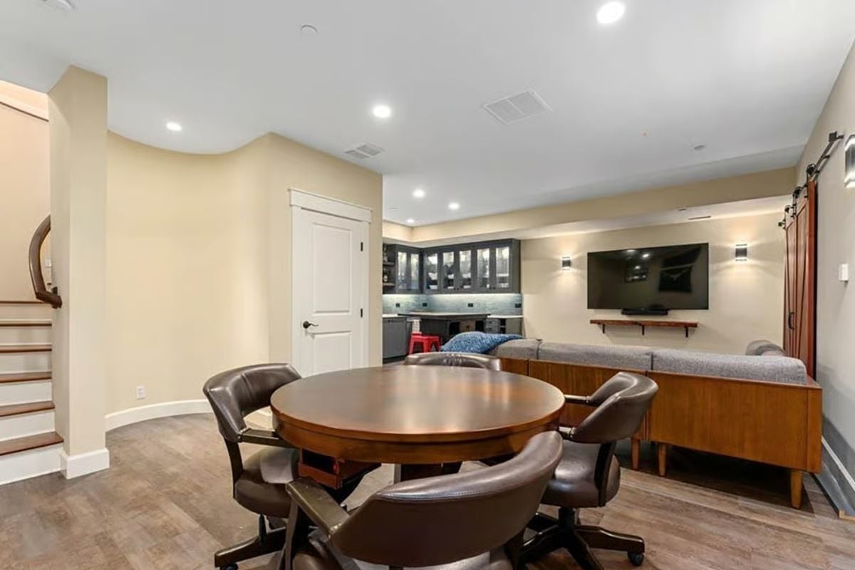 Poker Table in a Finished Basement That Knows Exactly What It Is