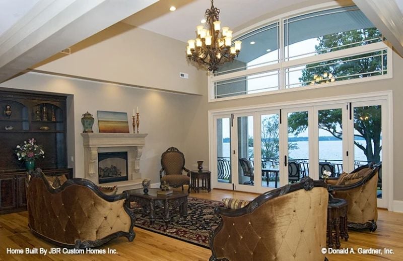 Tufted Velvet and Ironwork Chandelier Anchor a Living Room Built for the Long View